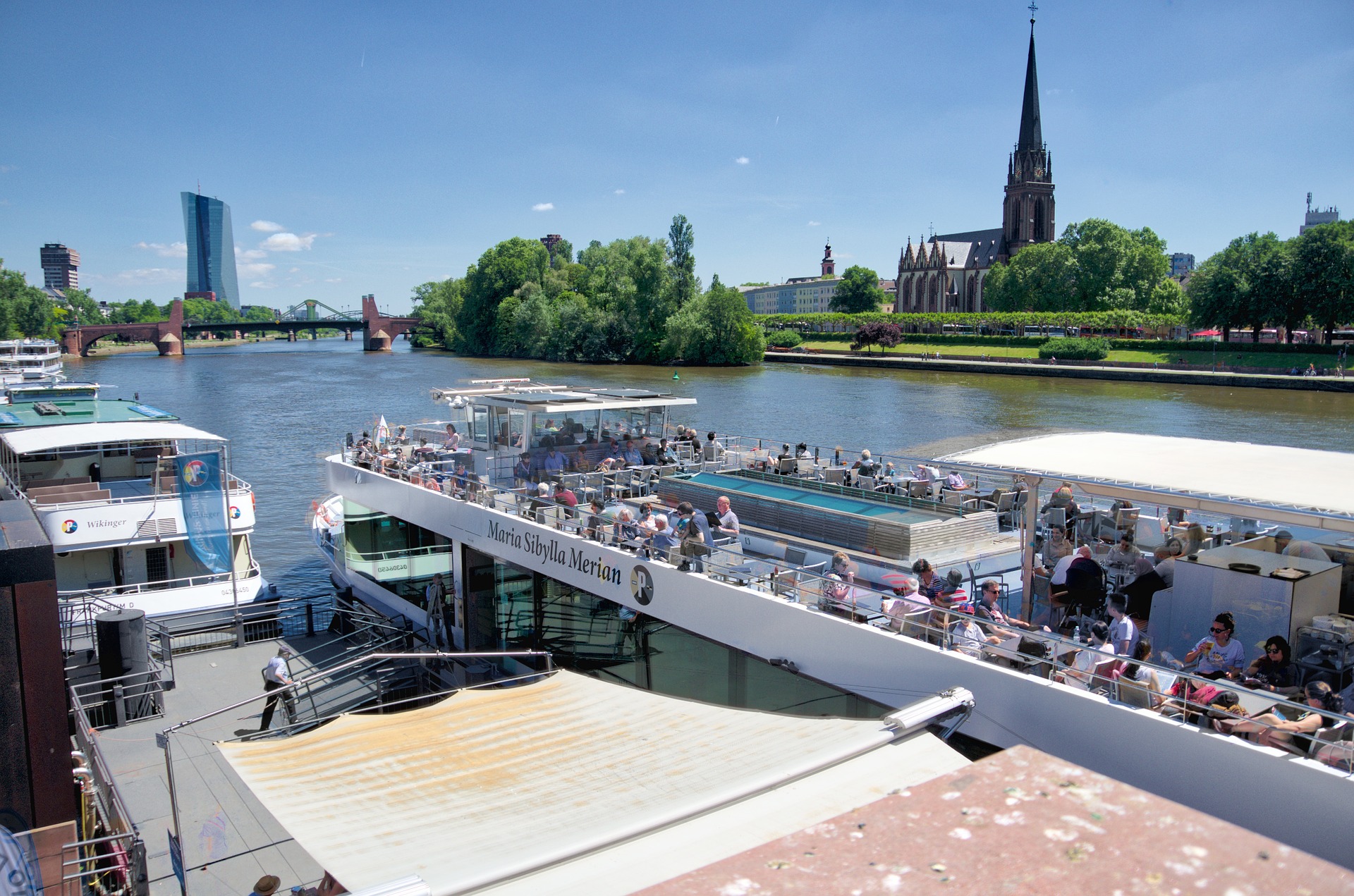 River boat with Dreikönigskirche church in background, Frankfurt, Germany