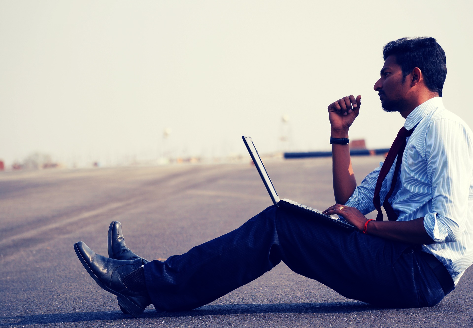 Man sitting on floor with laptop