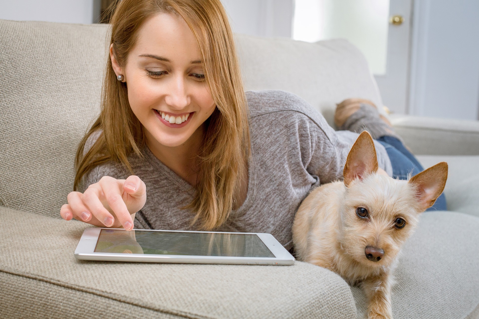 Woman with dog using tablet